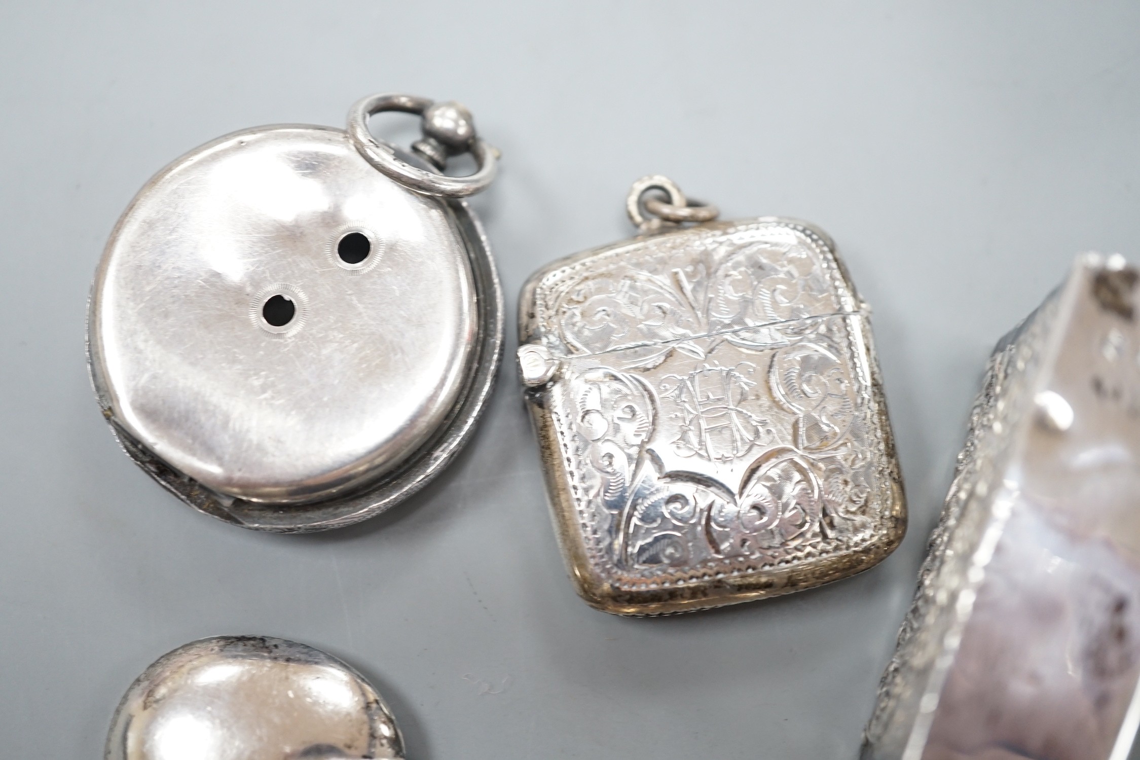 A late Victorian novelty white metal propelling pencil, modelled as a tennis racket, by Sampson Mordan & Co, 64mm, together with a watch case, silver vesta case, spoon and silver matchbox sleeve.
